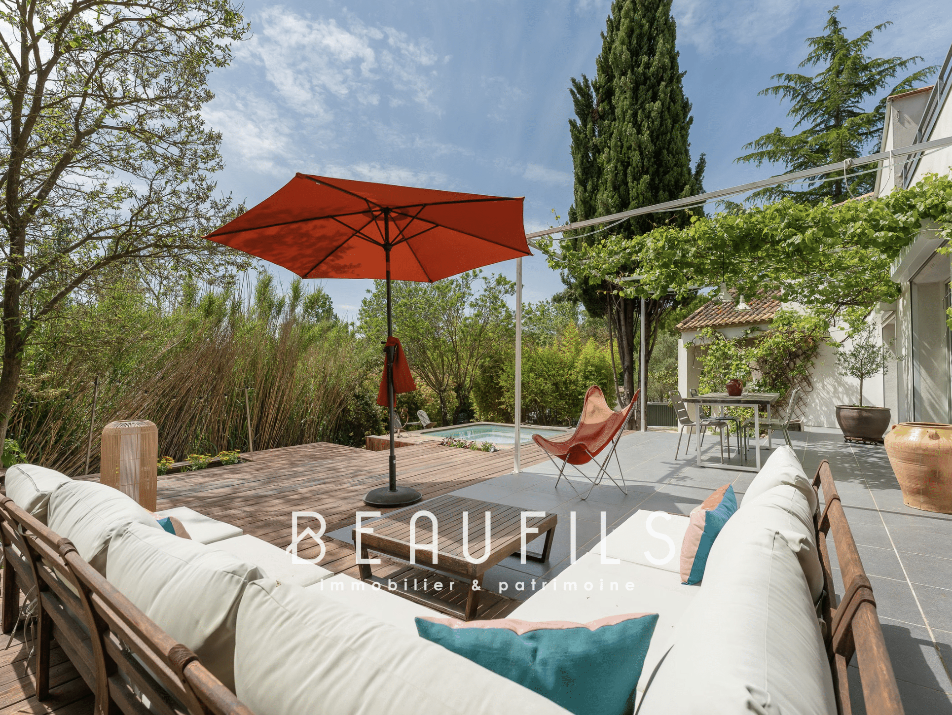 Terrace of an architect-designed villa with parasol and garden furniture in Montferrier-sur-Lez.