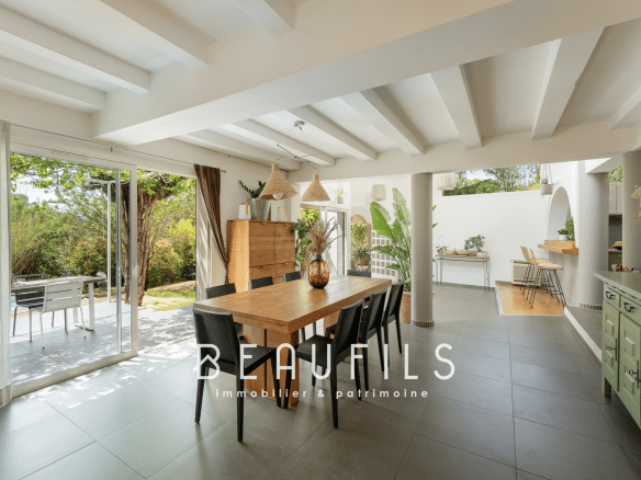 Interior of an architect-designed villa with dining room and access to the outside, Montferrier-sur-Lez.