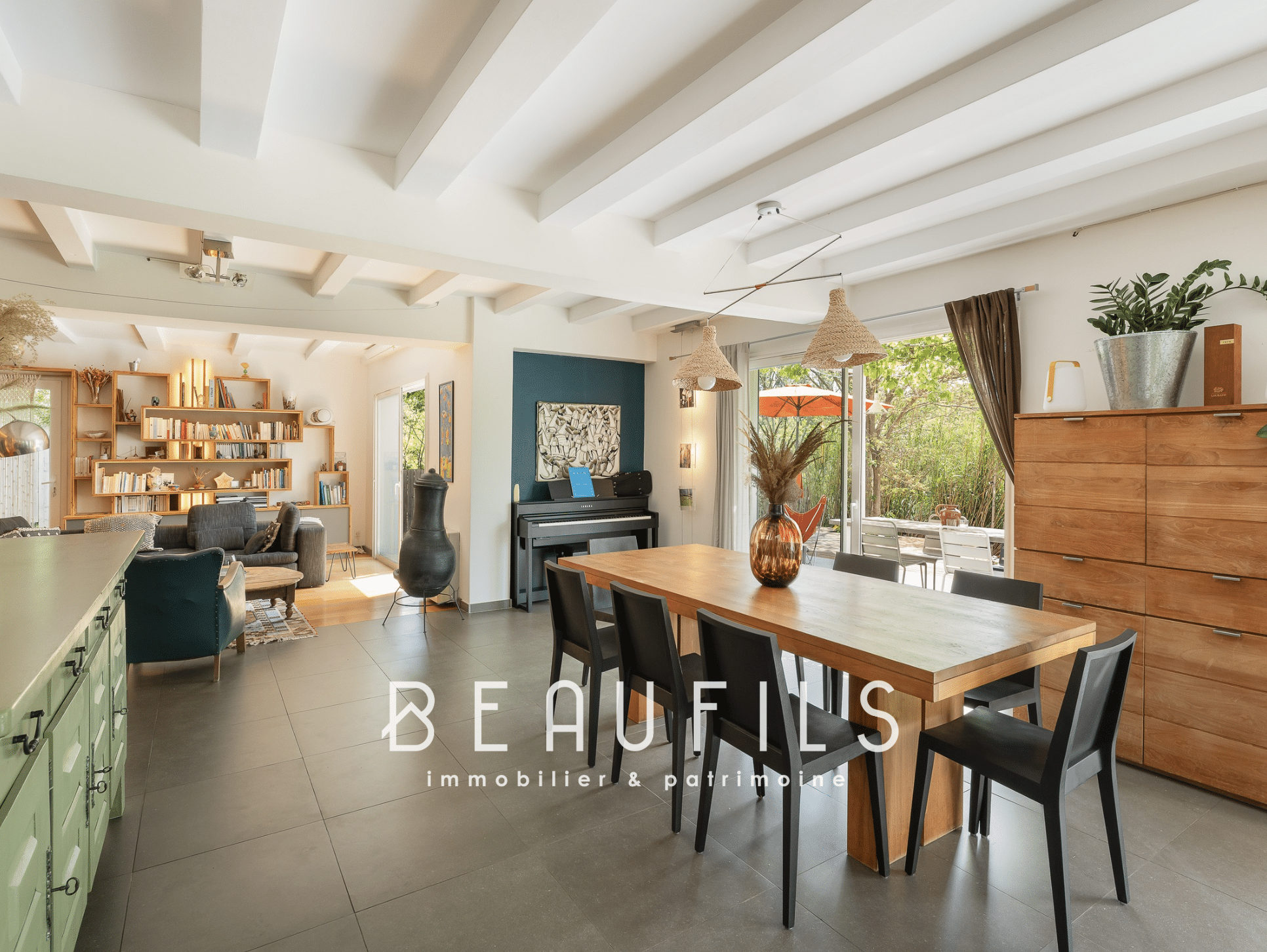 Interior of an architect-designed villa with dining room, living room and access to the outside.