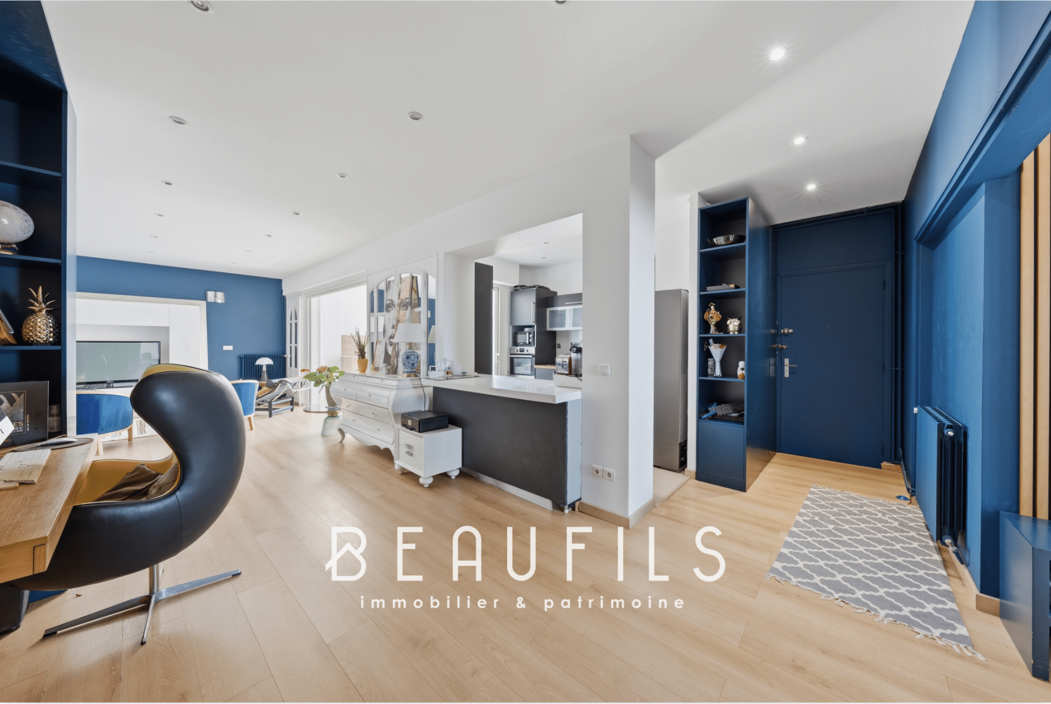 Interior of a modern apartment with living room, open kitchen and contemporary decor.