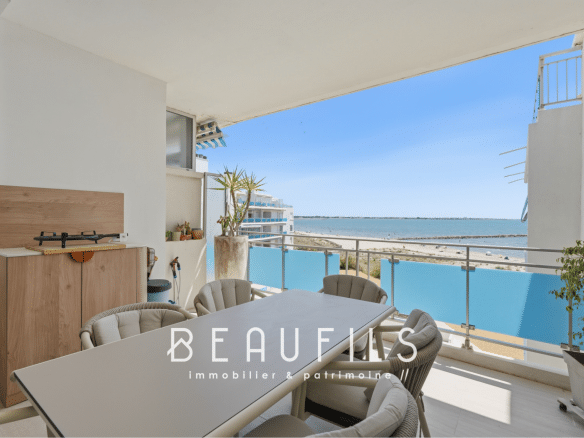 Terrace of an apartment with sea view in Le Grau-du-Roi, modern furniture and dining table.