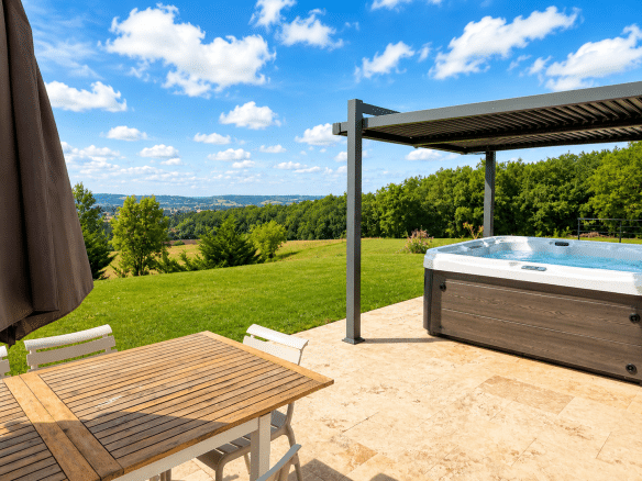 Terrace of a renovated stone property with jacuzzi and countryside views in Le Lédat.