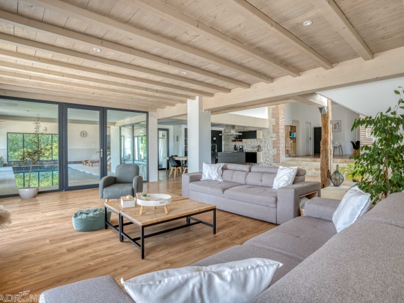 Interior of a renovated stone property with a large, bright and modern living room.