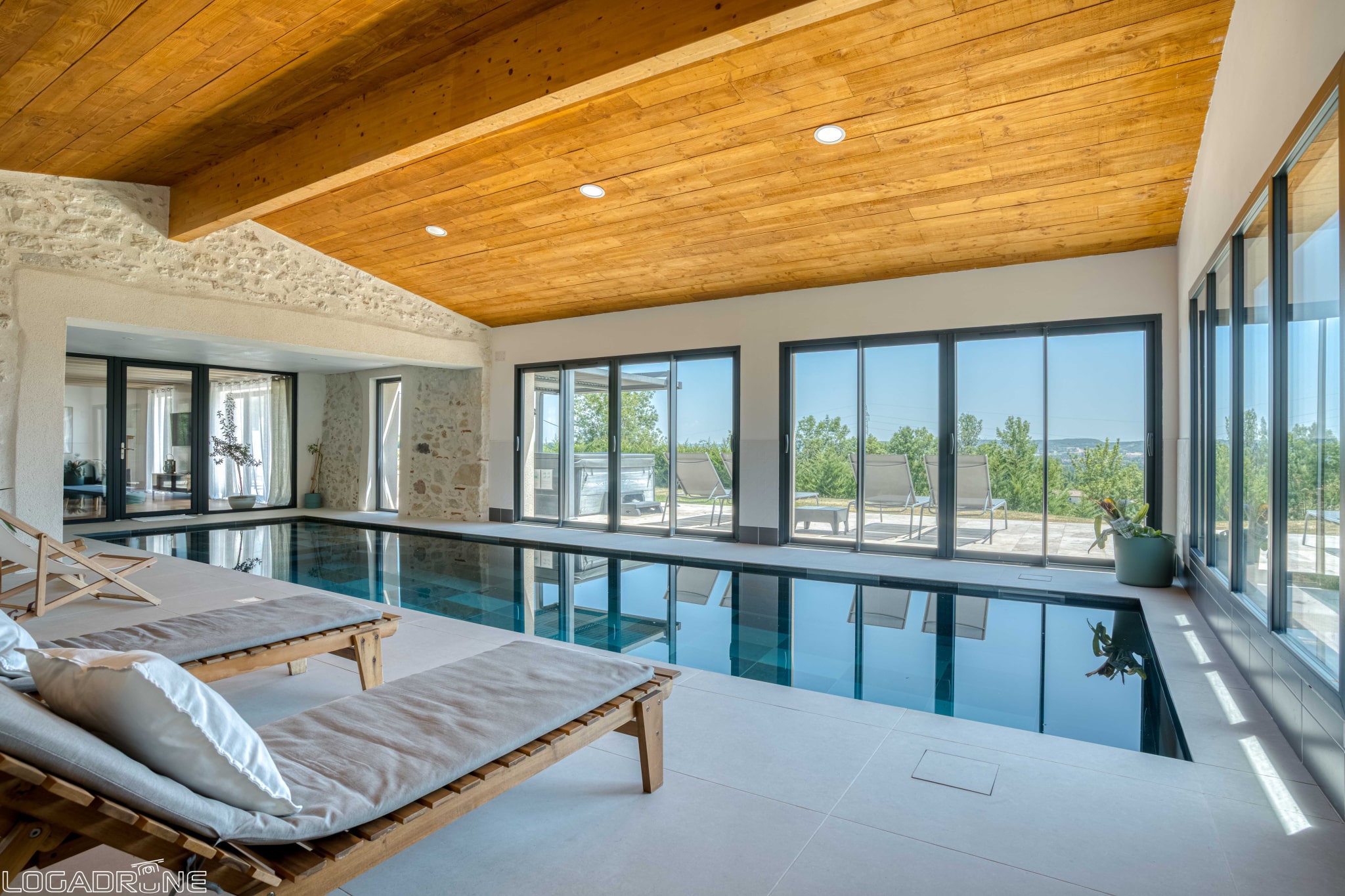 Interior of a renovated stone property with swimming pool and countryside views in Le Lédat.
