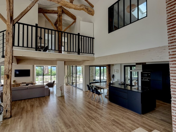 Interior of a renovated stone property with large living spaces and views of the countryside.