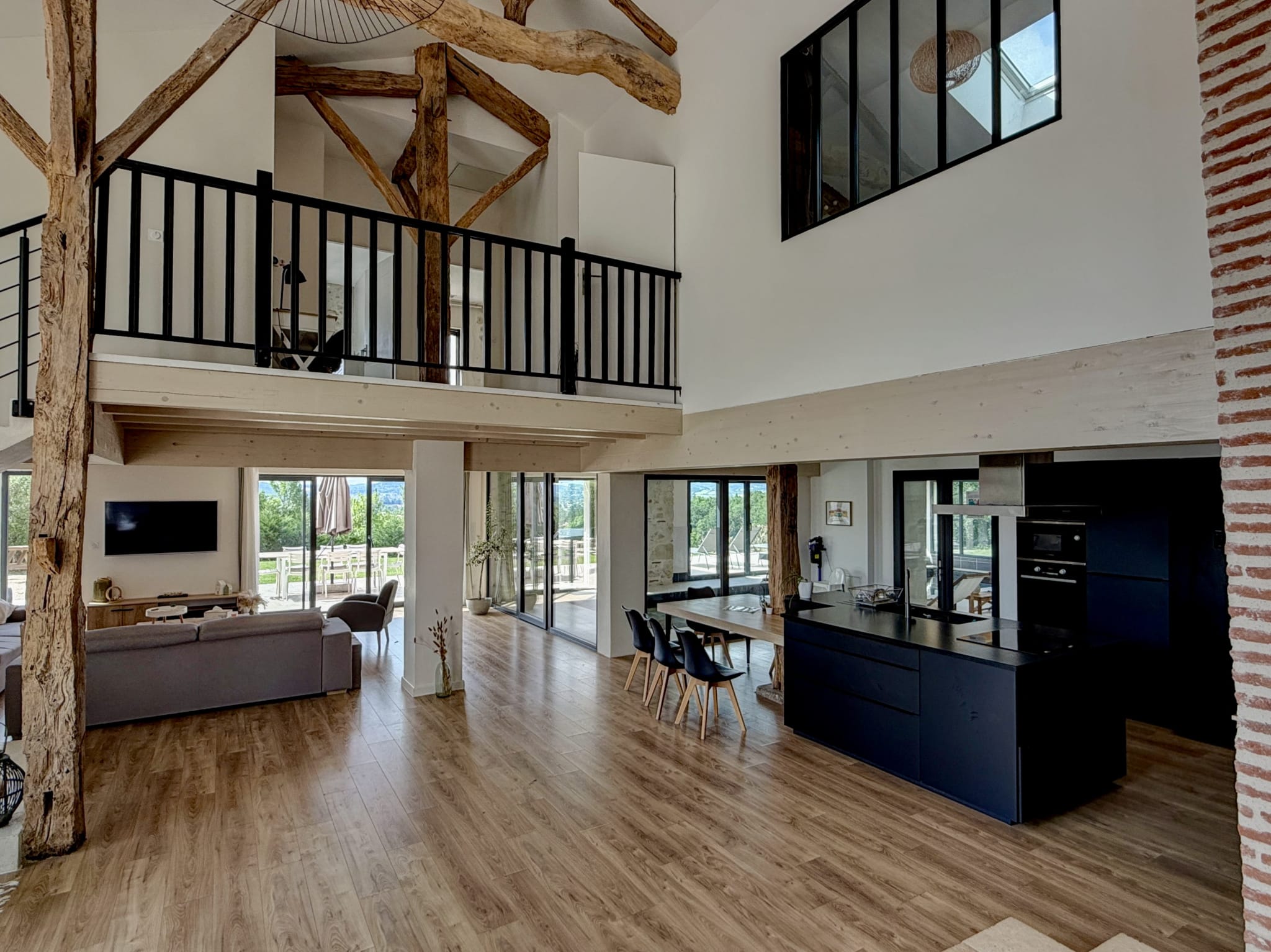 Interior of a renovated stone property with large living spaces and views of the countryside.
