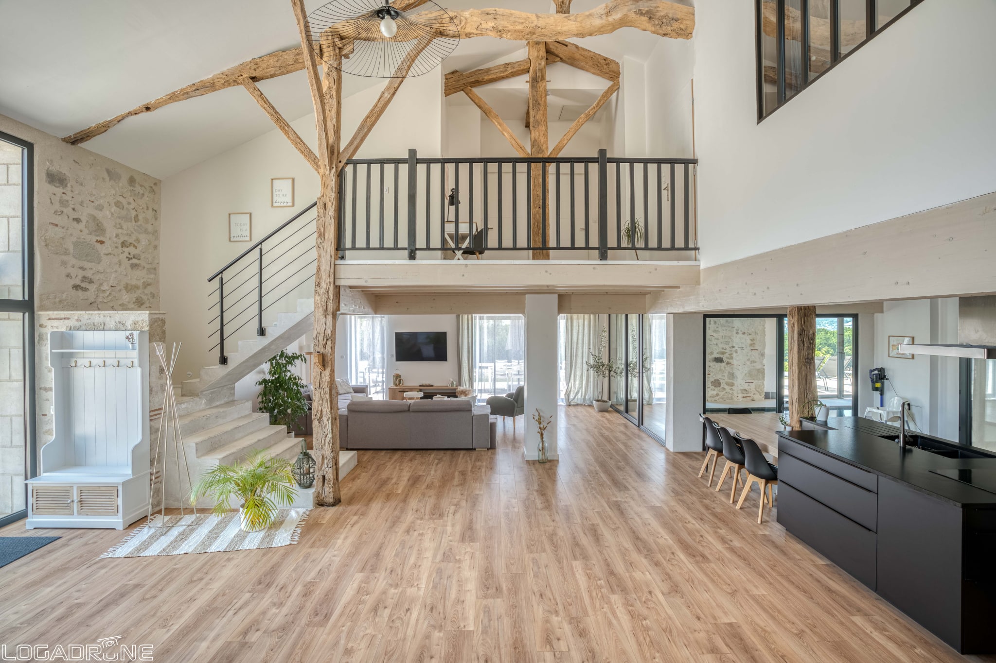 Interior of a renovated stone property with a large living space and a mezzanine.