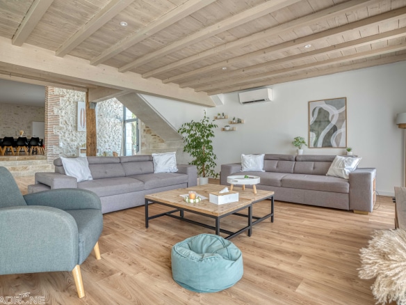 Interior of a renovated stone property with a spacious living room and modern decor.