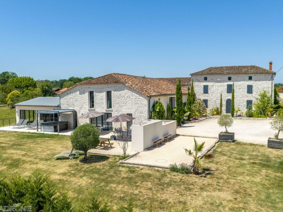 Renovated stone property with outbuildings in Le Lédat, unobstructed views of the countryside.