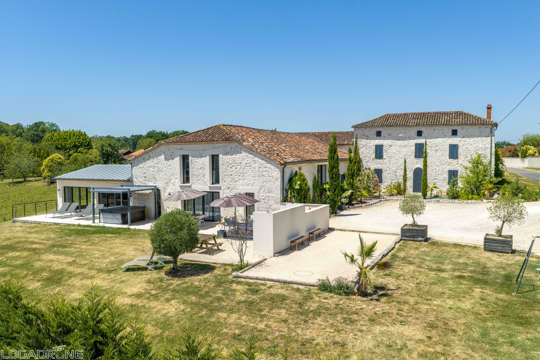 Renovated stone property with outbuildings in Le Lédat, unobstructed views of the countryside.