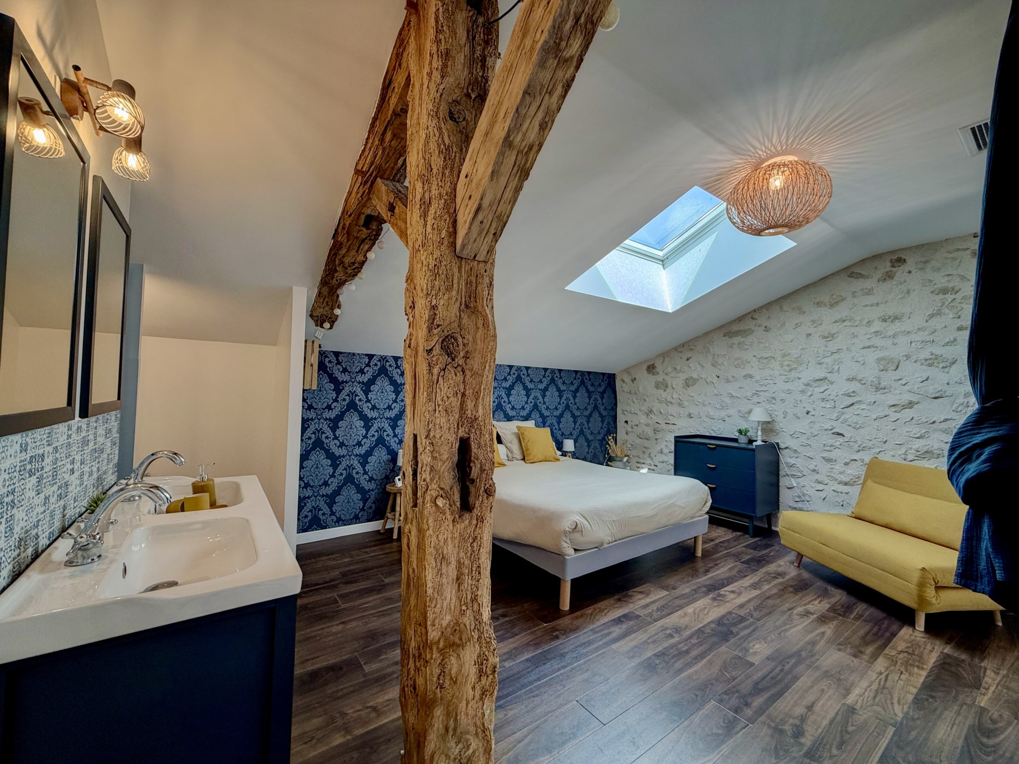 Room in a renovated stone property with bathroom and skylight.