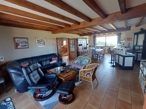 Interior of a house with living room, dining room and open kitchen, sea view.