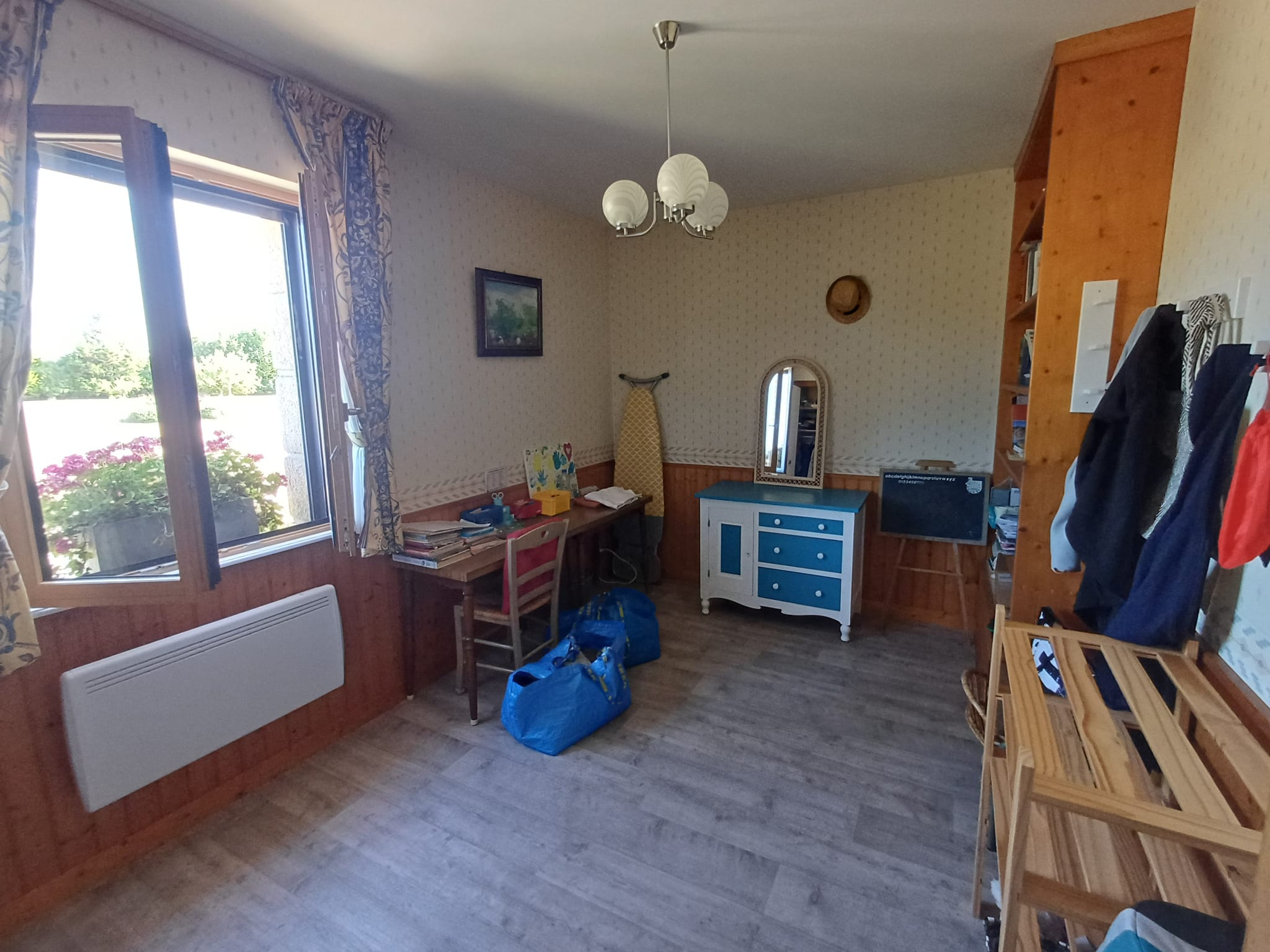 Interior of a house in Plougasnou, with furniture and windows letting in light.