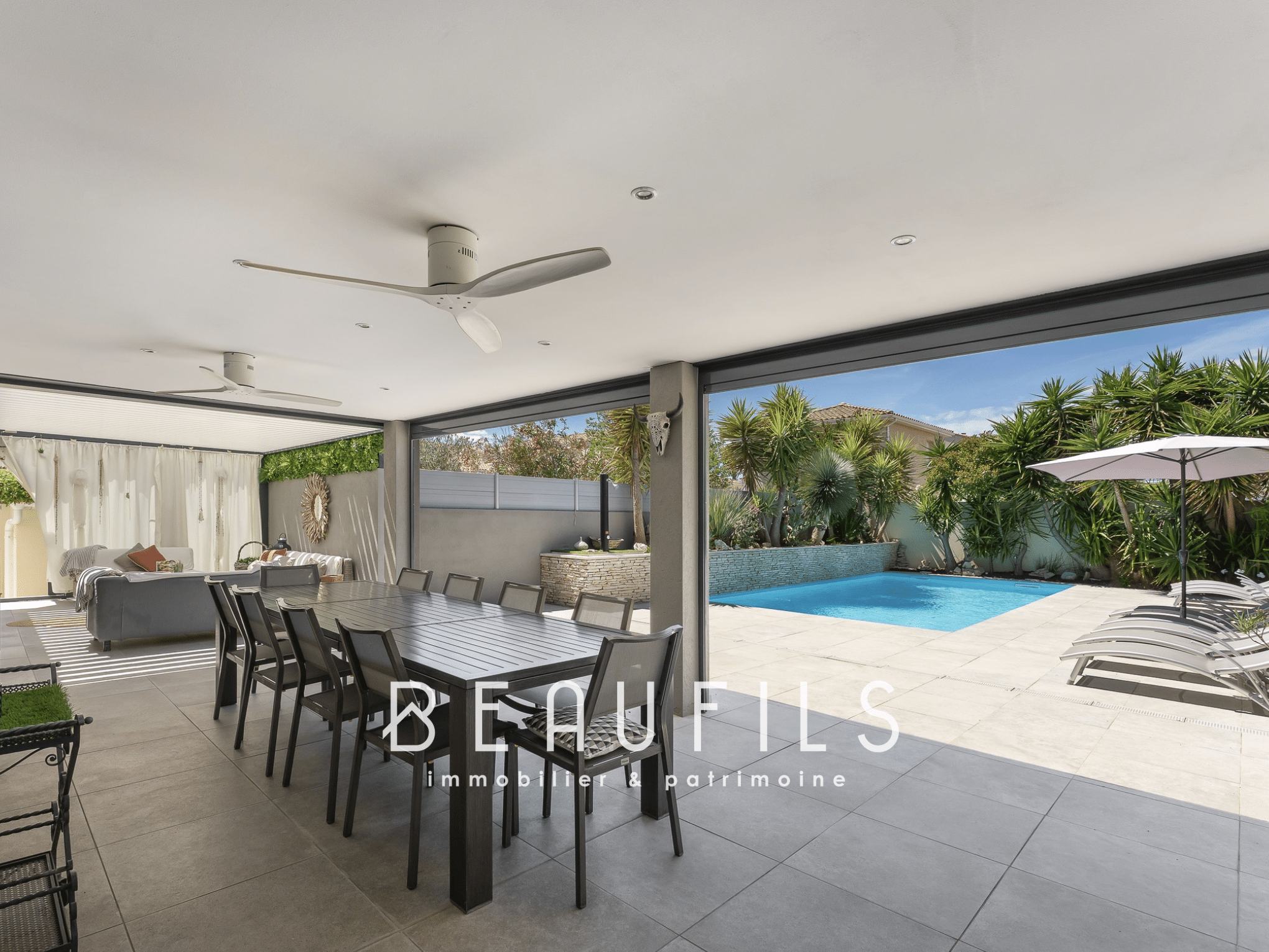 Terrace of a Mediterranean villa with swimming pool in Saint-Laurent-d'Aigouze, modern furniture and living space.