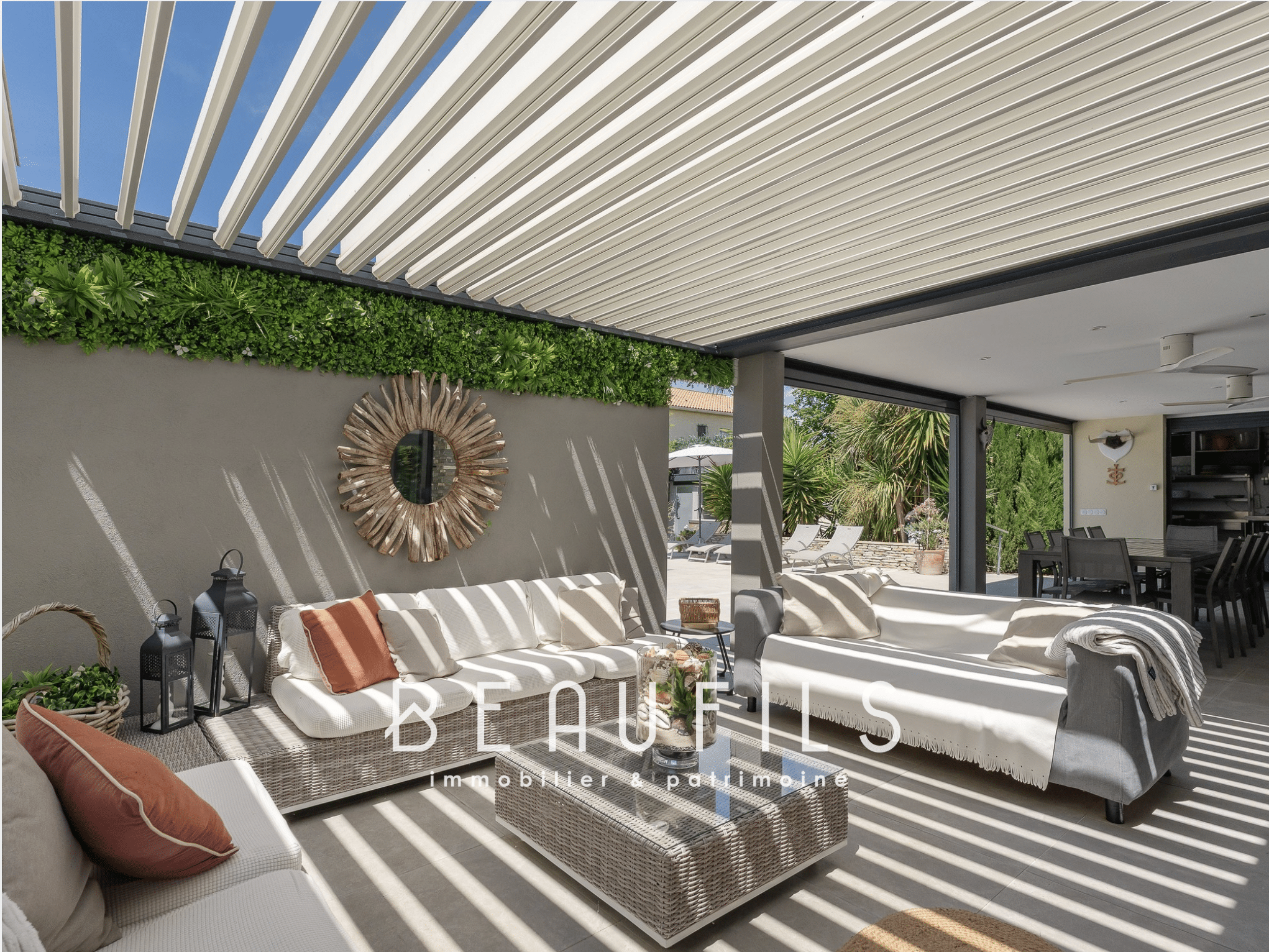 Living space in a Mediterranean villa with covered terrace and comfortable furniture.