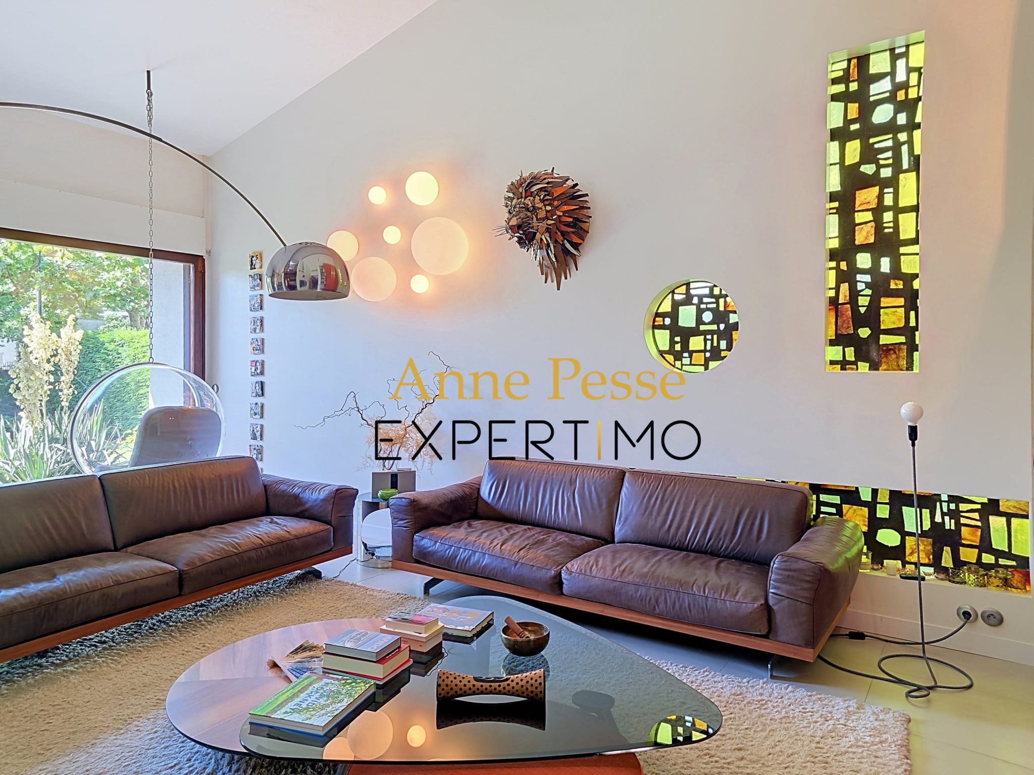 Interior of a modernist villa with leather sofas and artistic decoration.