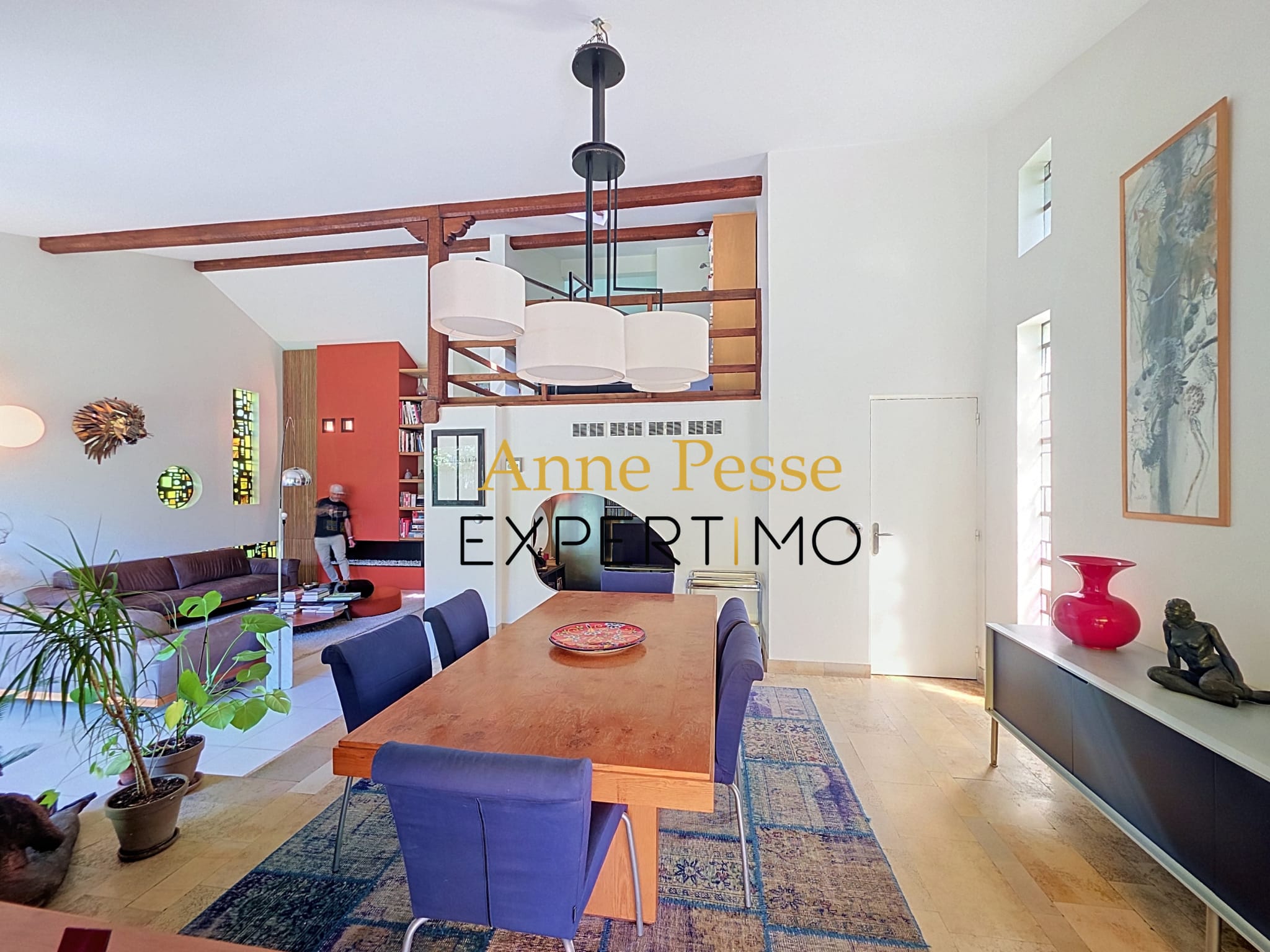 Interior of a modernist architect-designed villa with a bright dining room and living room.
