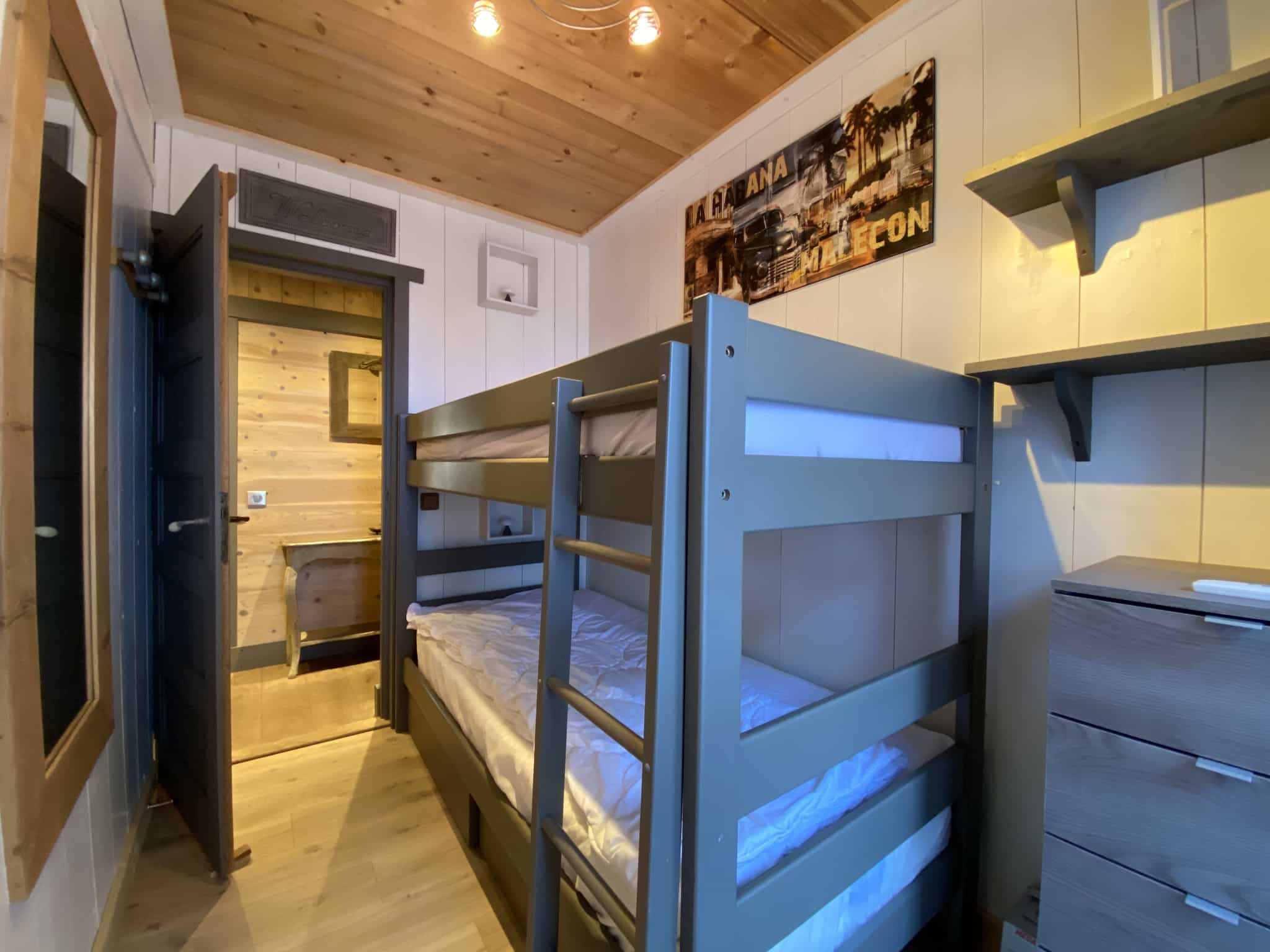 Room in a renovated apartment with bunk beds and wooden decor in Megève.