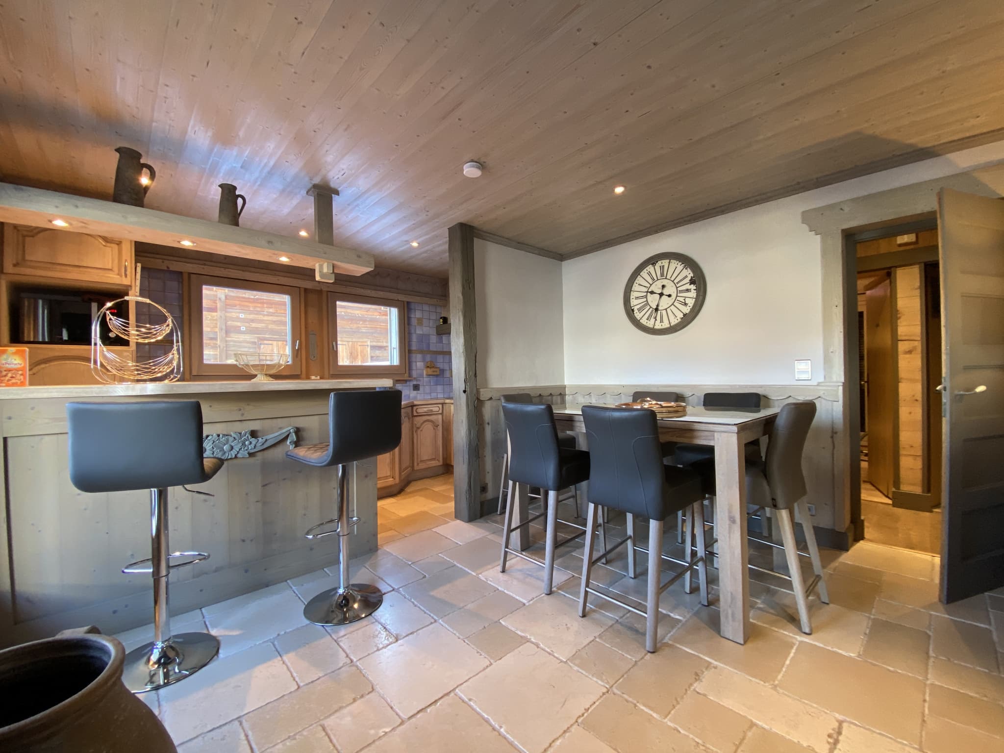 Interior of a renovated apartment with kitchen and dining room, modern wooden furniture.