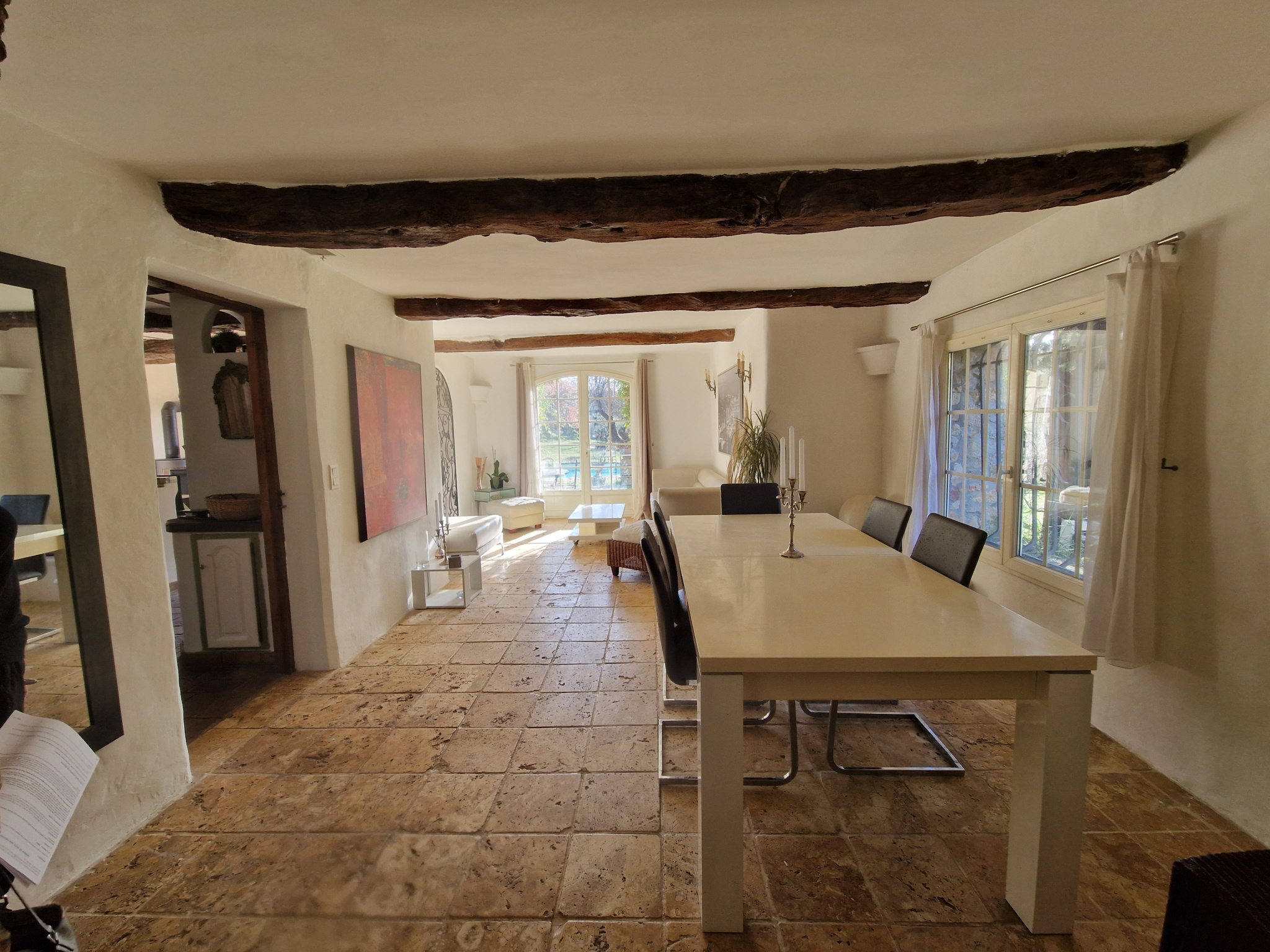 Intérieur d’une bastide à Lorgues Intérieur d'une bastide provençale avec une salle à manger lumineuse et des poutres apparentes.