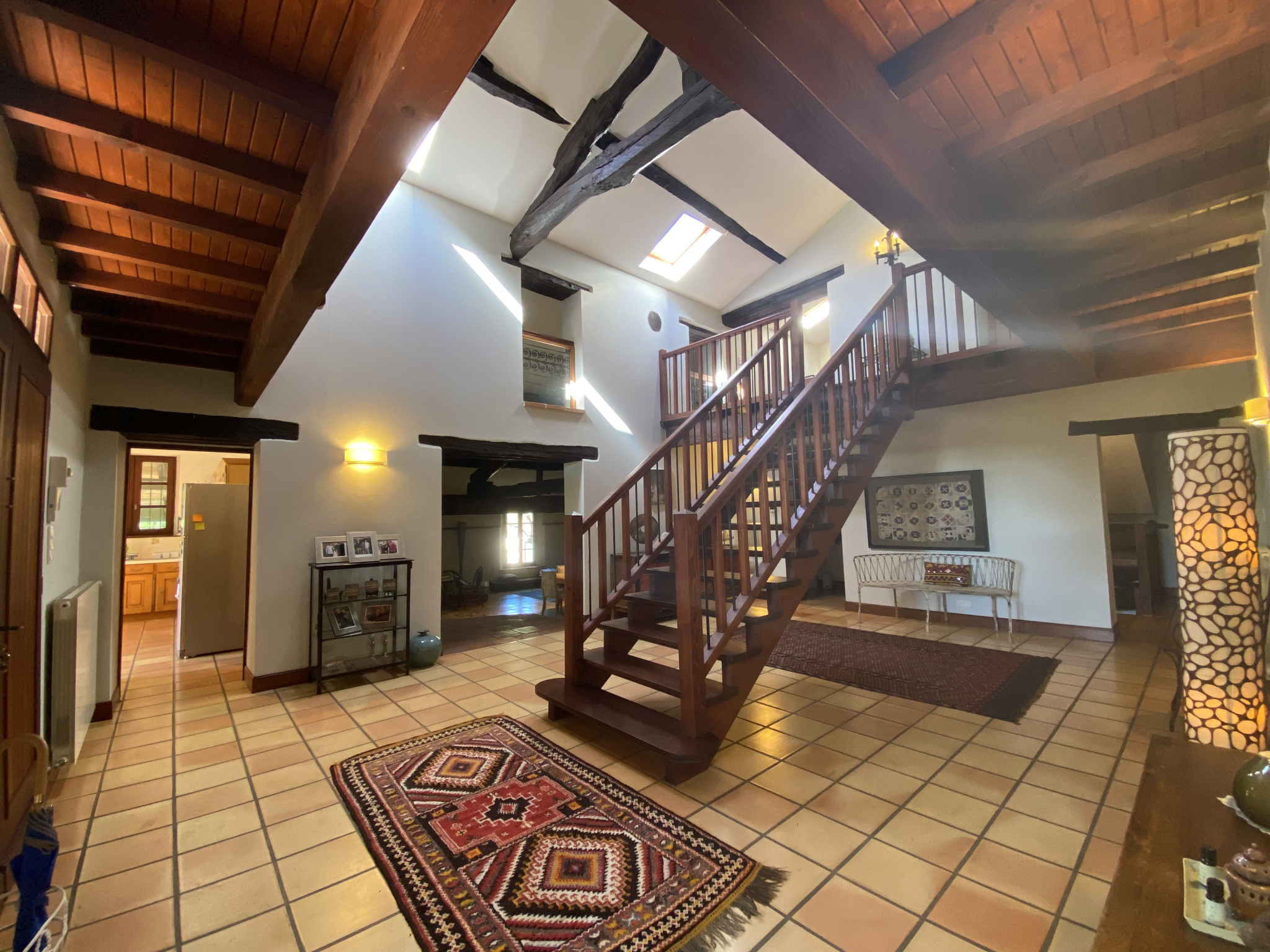 Interior of a country house in Moissac Interior of a country house with a wooden staircase and a spacious living room.
