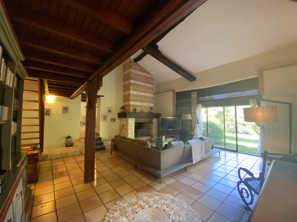 Interior of a country house with a bright living room and access to the garden.