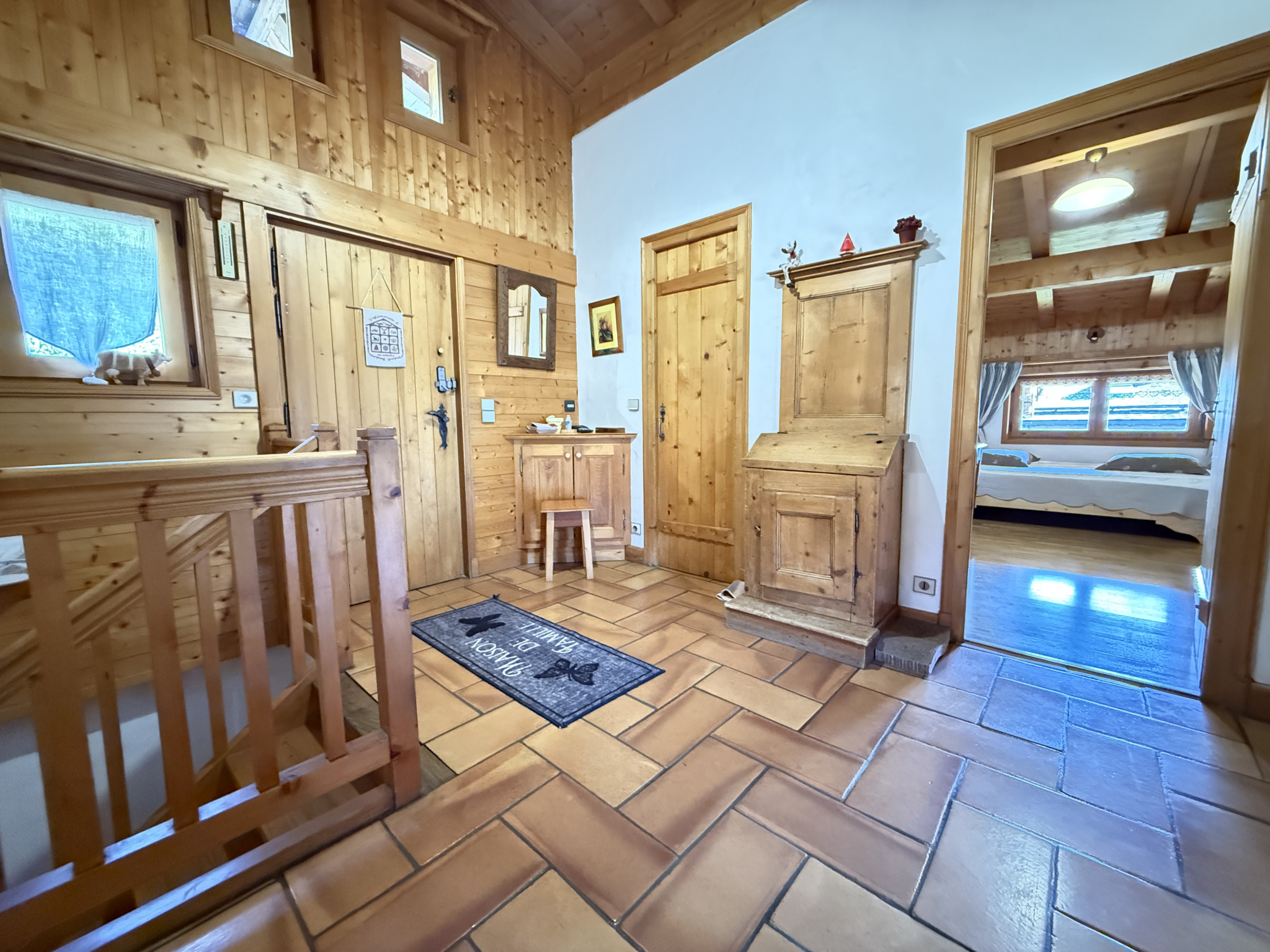 Interior of a traditional wooden chalet with an entrance hall and a pantry.
