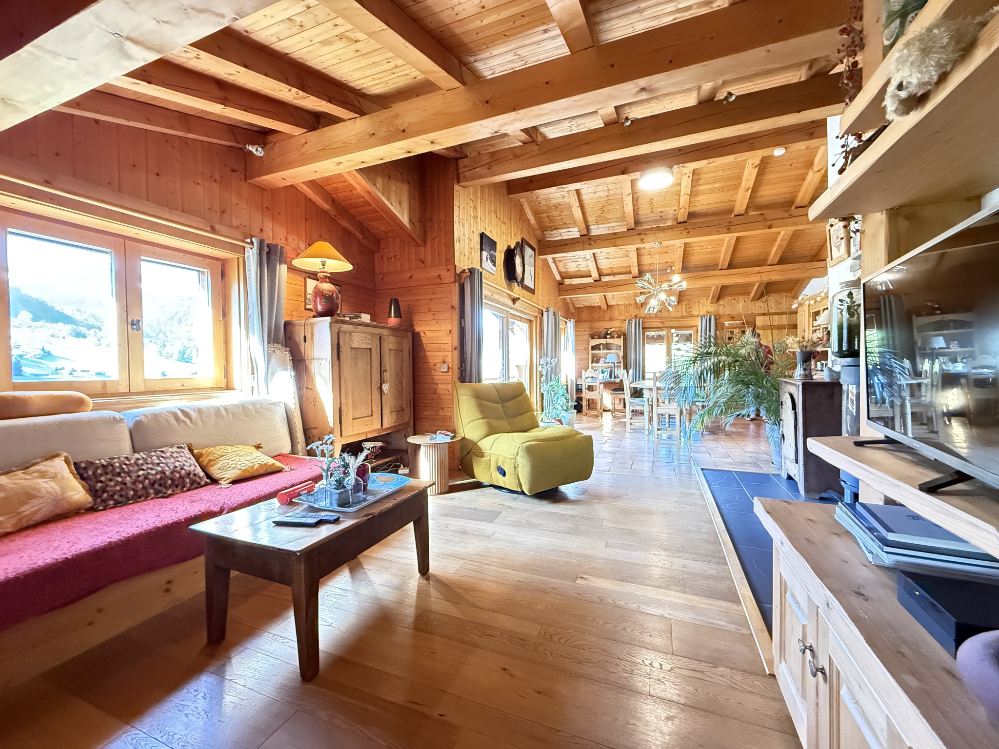 Warm interior of a traditional chalet with living room, sofa and wooden decor.