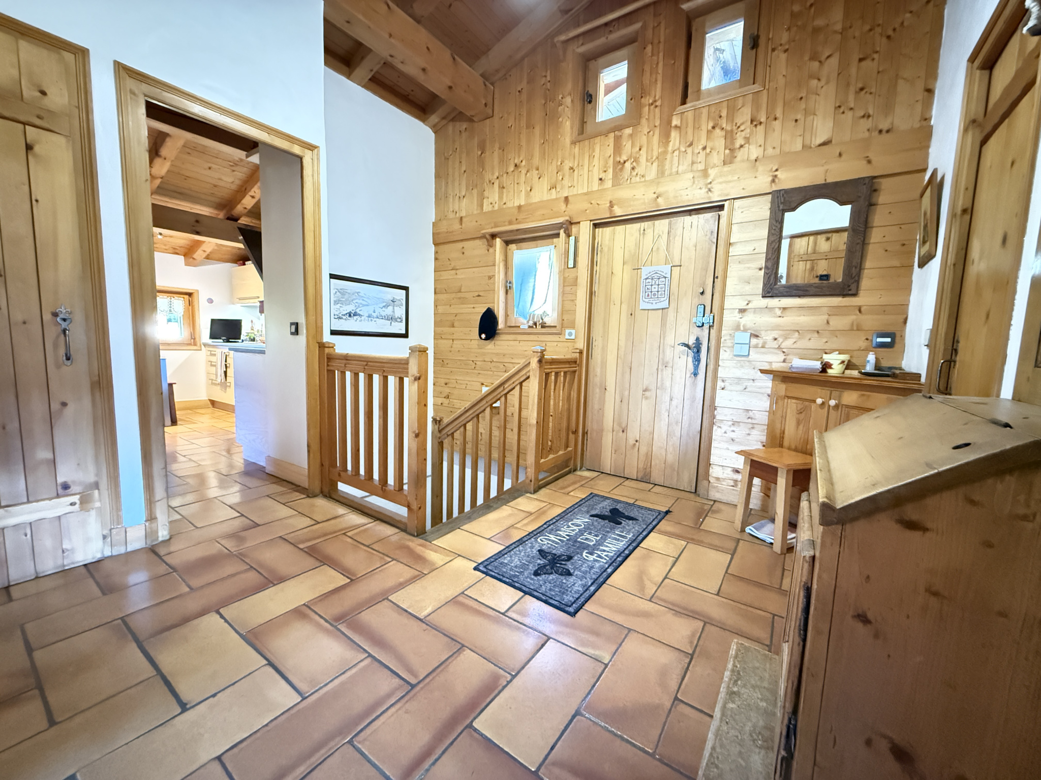 Interior of a traditional wooden chalet with a warm and well-arranged entrance hall.