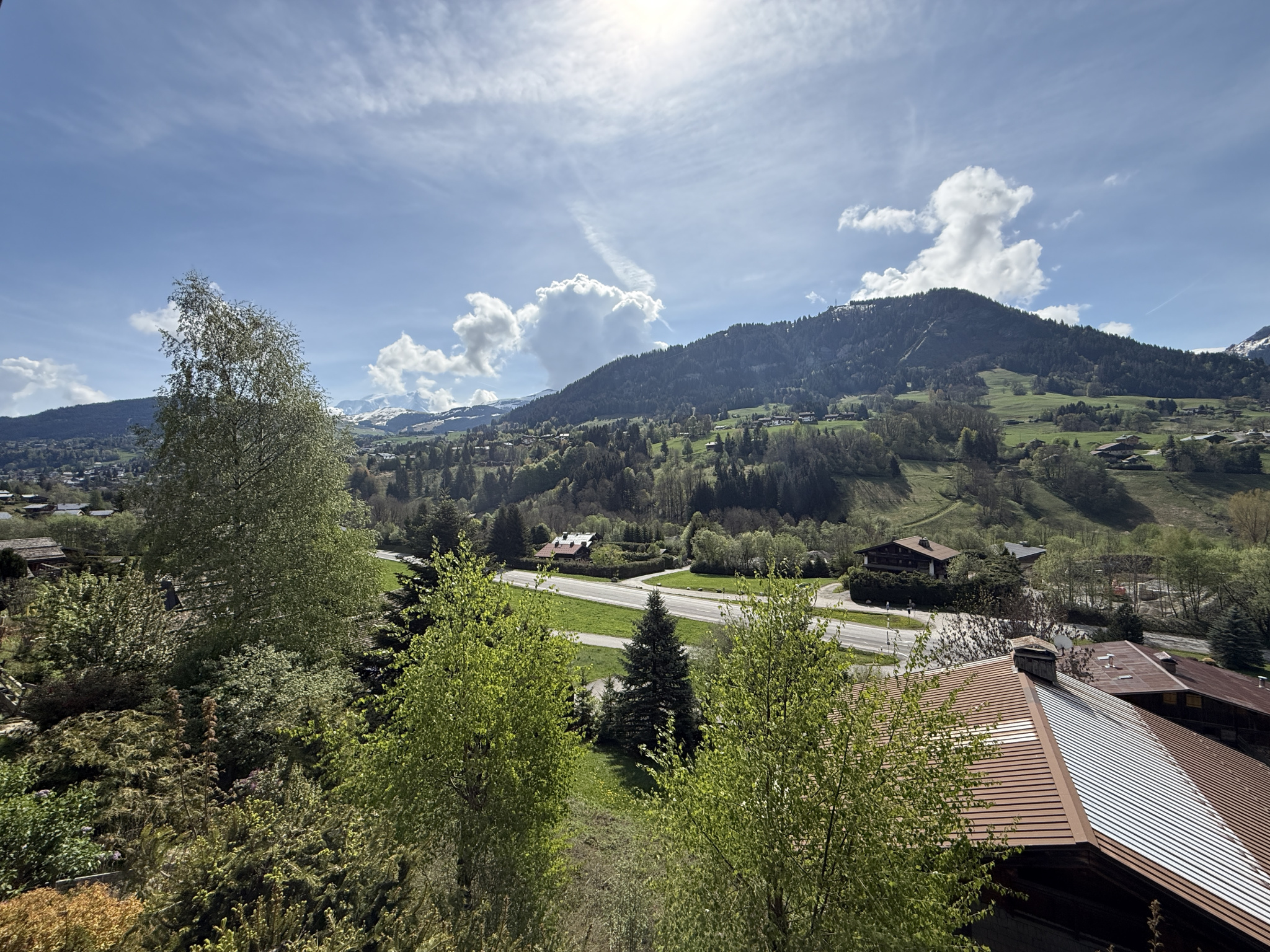 Panoramic view of the valley and mountains from a traditional chalet in Megève.