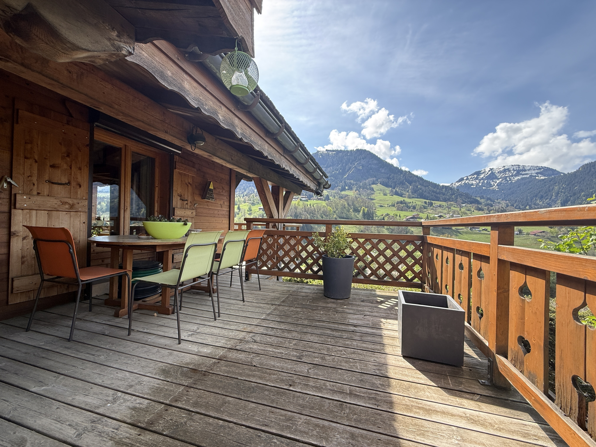 Wooden terrace of a traditional chalet with mountain views in Megève.