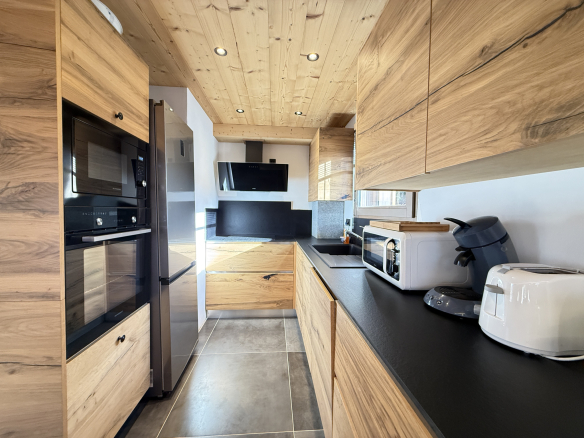 Modern wooden kitchen with appliances, alpine chalet in Combloux