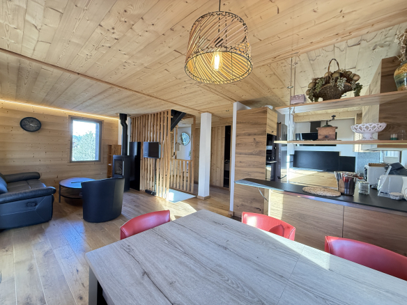 Interior of an alpine chalet in Combloux, with a living room and a modern kitchen.