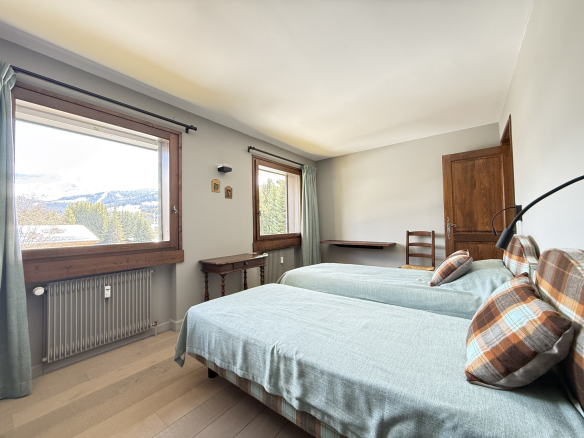 Room in a condominium with two single beds and mountain view.