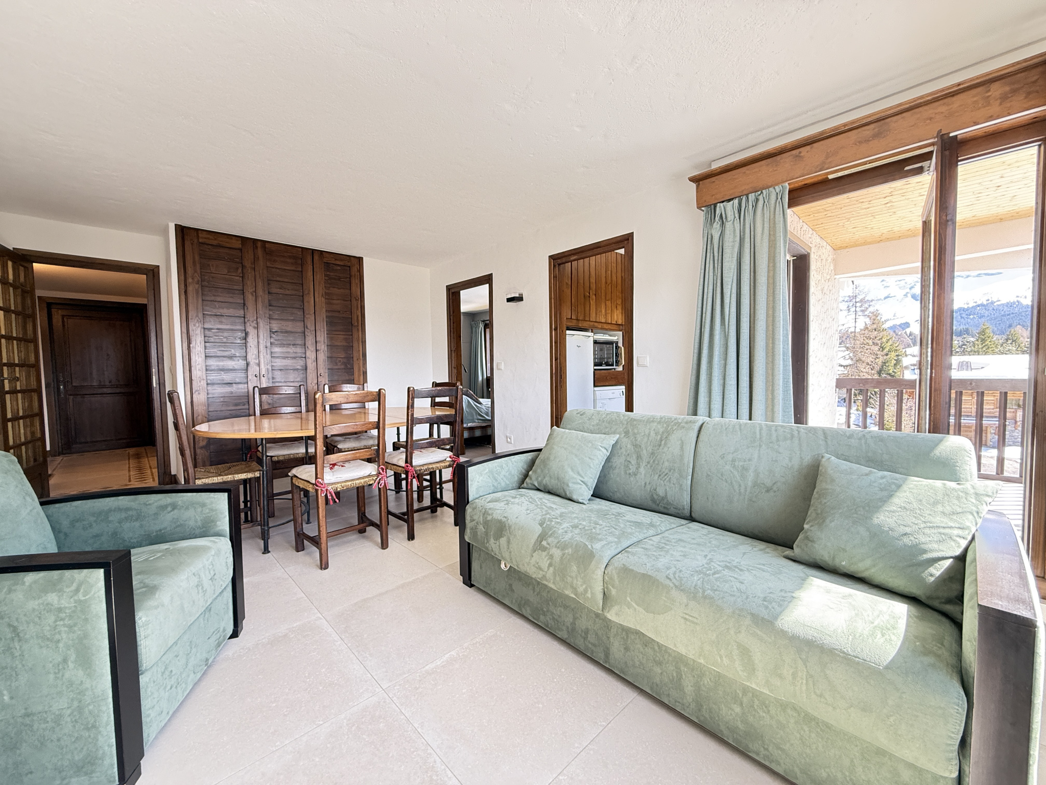 Interior of an apartment in Megève Interior of an apartment in the Les Mandarines condominium in Megève, with living room and dining room.