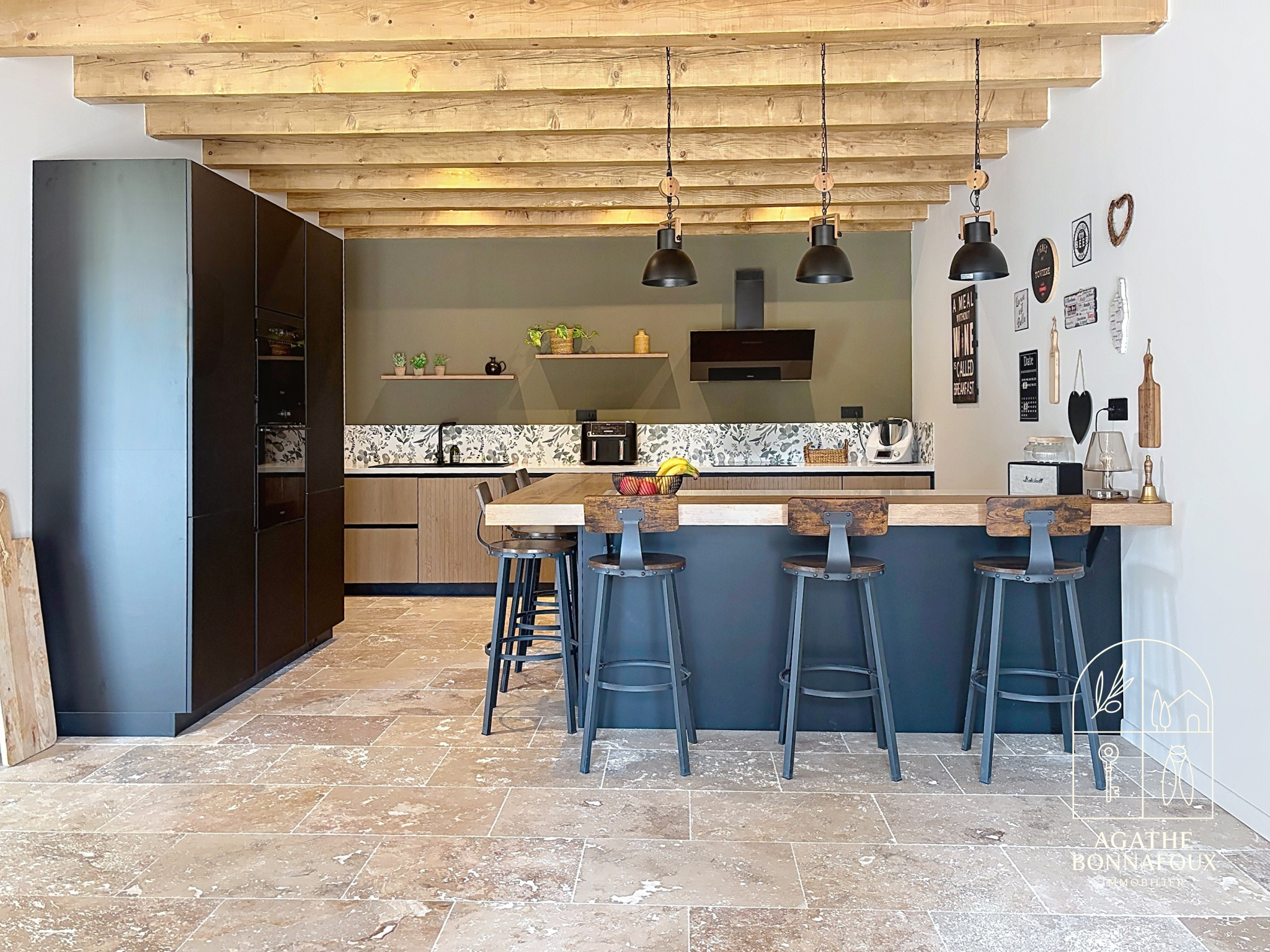 Modern kitchen in a renovated Provençal farmhouse with bar and stools, Châteaurenard.