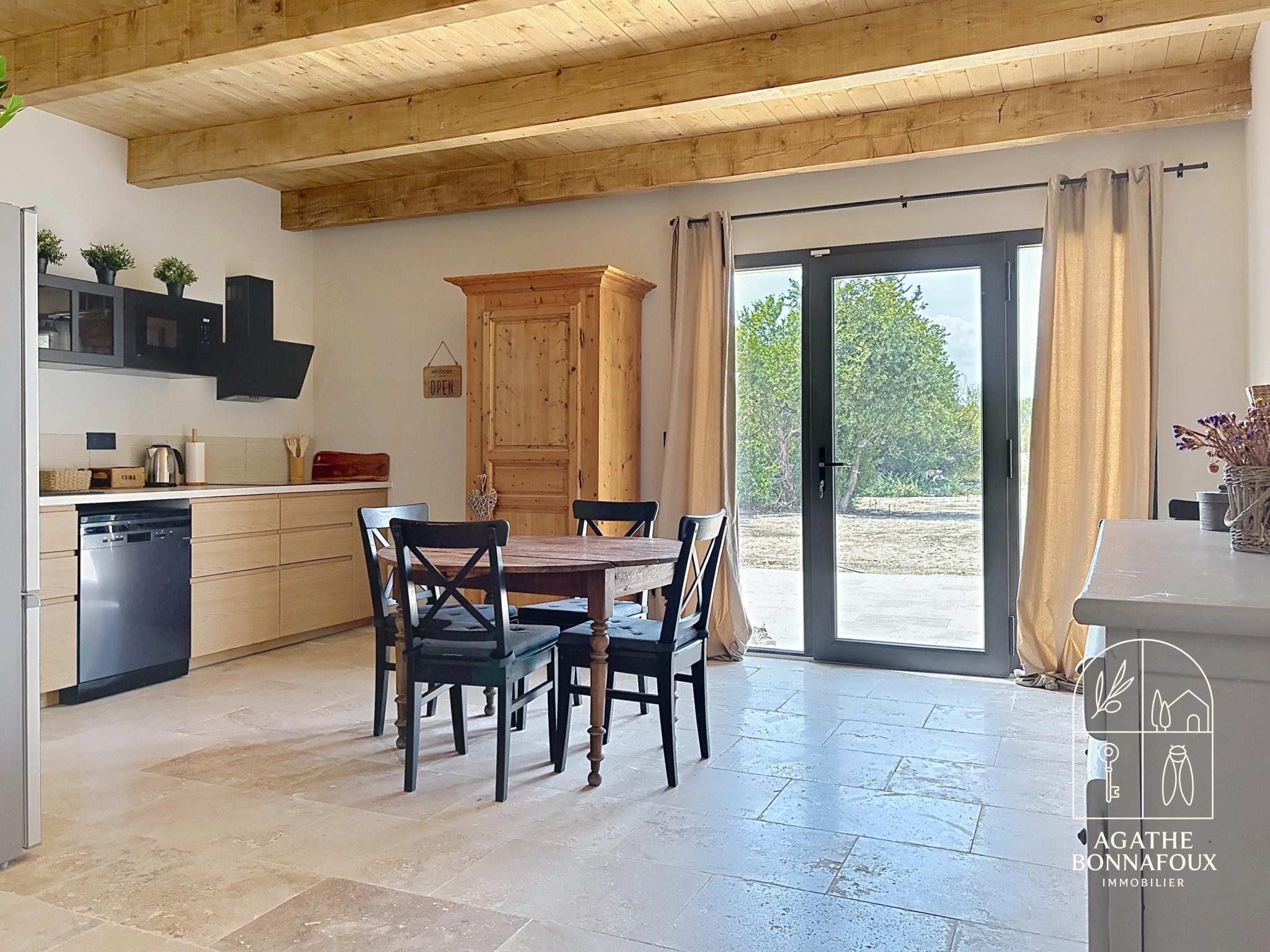 Interior of a renovated Provençal farmhouse with modern kitchen and dining table, Châteaurenard.