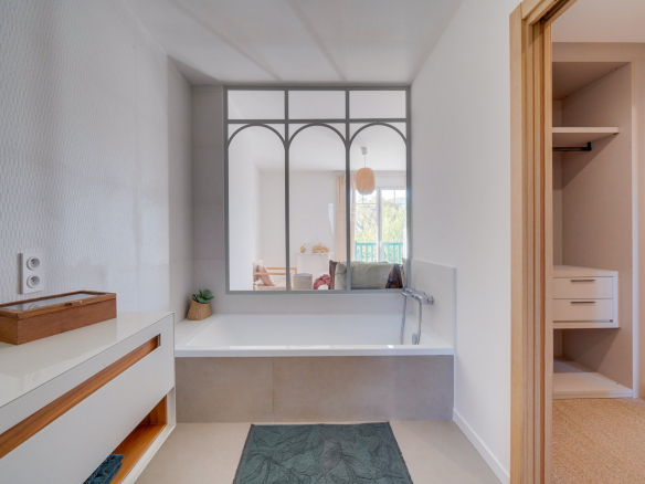 Salle de bain moderne avec baignoire et rangement, maison à Urrugne