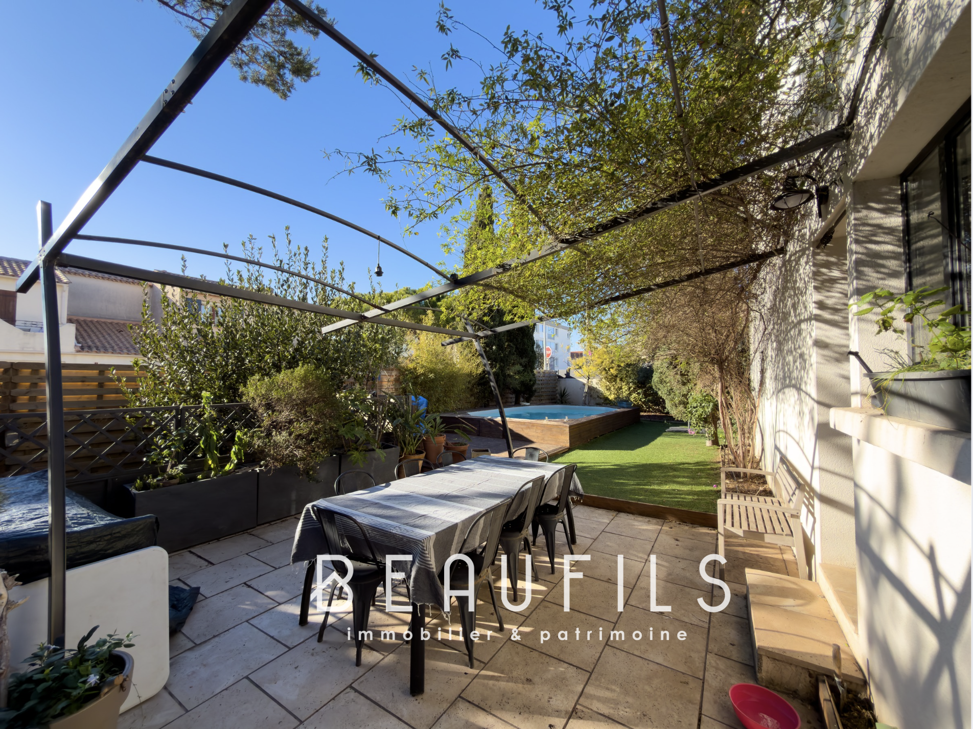 Terrace of a villa with swimming pool and garden in Frontignan.