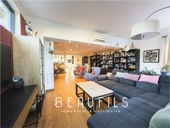 Interior of a renovated family villa with a large living room and open kitchen.