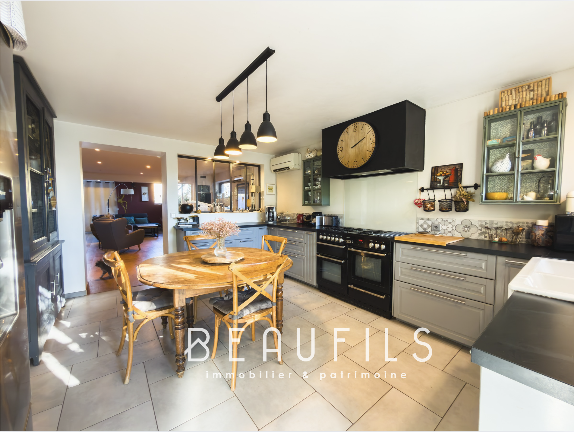 Modern kitchen with dining table in a renovated villa in Frontignan.