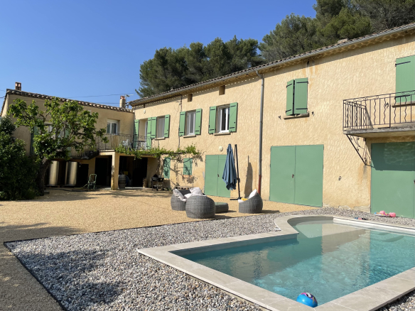 Property with swimming pool and guest rooms in Faucon, Provence, surrounded by vineyards.