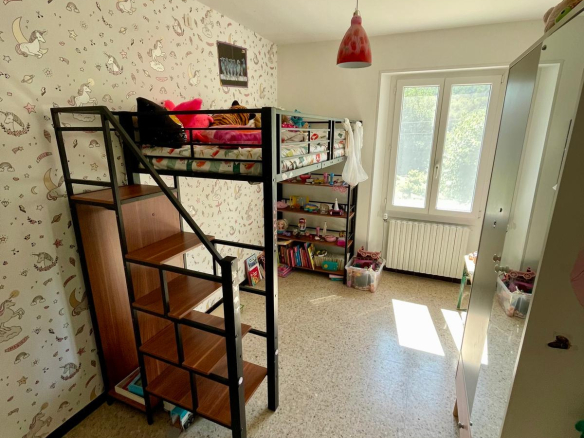 Guest room with bunk bed and shelves in a quiet environment.