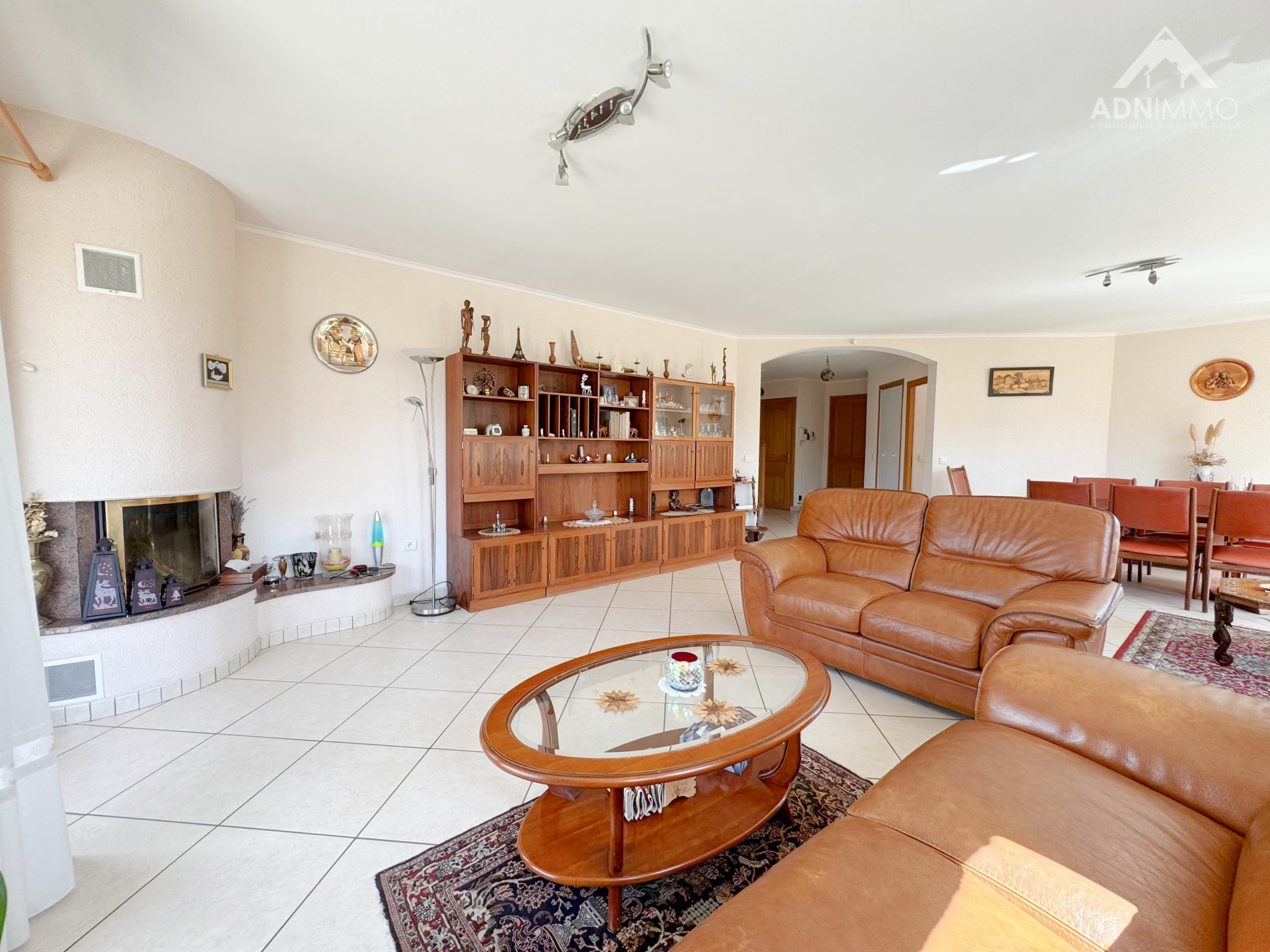 Living room of a house in Sergy Interior of a house with a bright living room, a leather sofa and a built-in bookcase.
