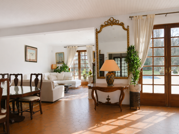 Interior of a spacious house with a bright living room and access to the outdoor pool.
