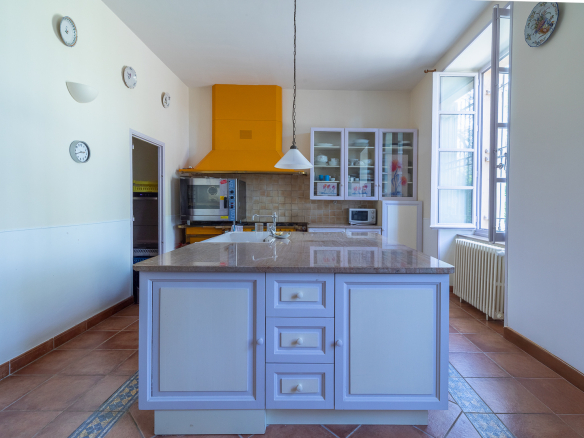 Modern kitchen with a central island and appliances in a castle in Pézenas.