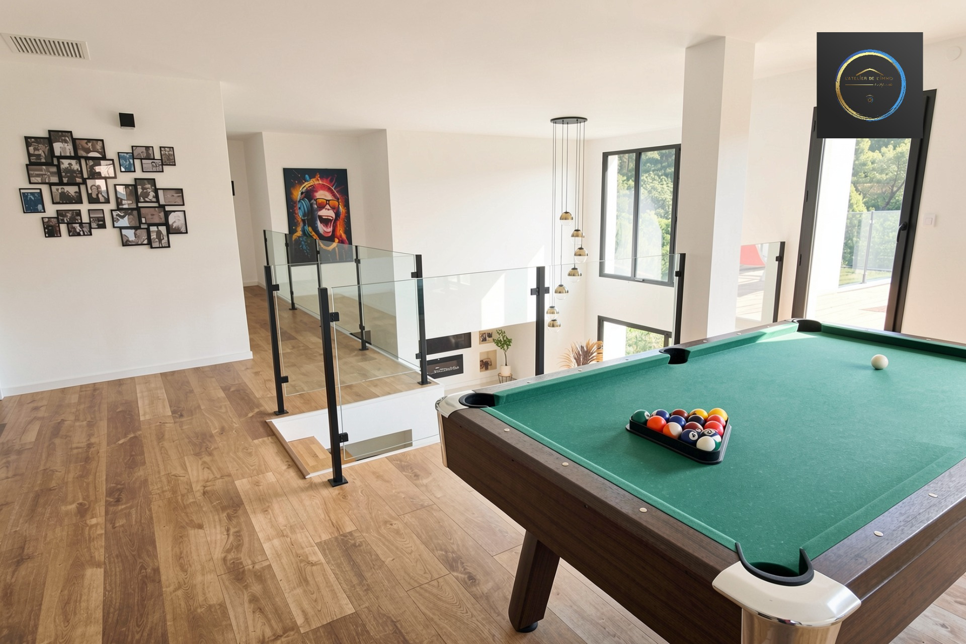 Interior of a contemporary villa in Clermont-l'Hérault Interior of a contemporary villa with a pool table and large windows.