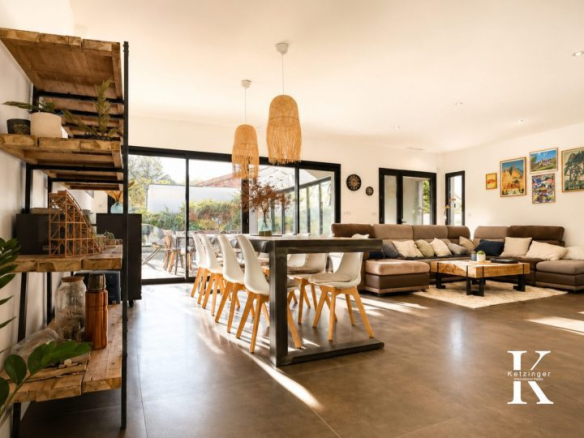 Interior of a contemporary villa with a spacious living room and dining room.