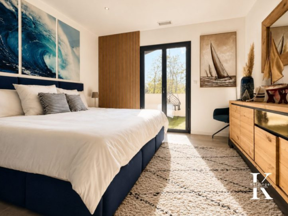 Modern room with king-size bed, nautical decor and access to a balcony.