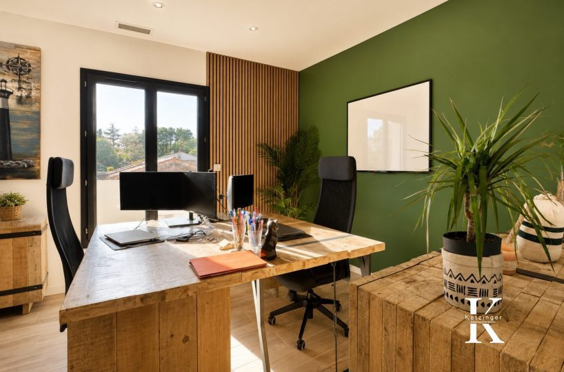 Modern office in a contemporary villa with green walls and wooden furniture.